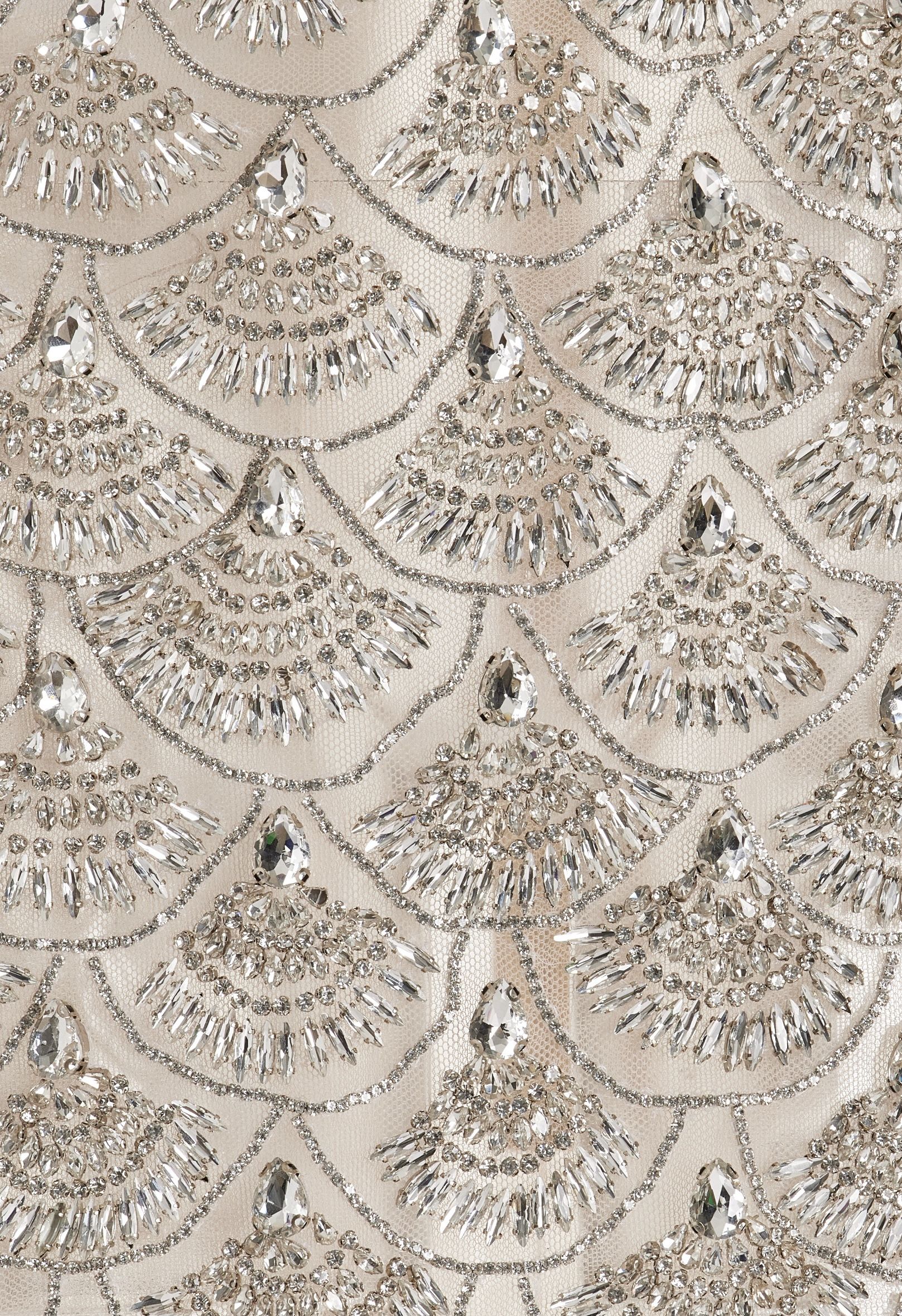 Delicate fan-shaped beadwork on champagne cloth, from AFIA’s visual references